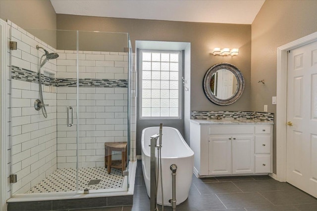 12505 Stapp Ct, Austin, TX 78732 - full bath featuring a shower stall, tile patterned floors, a freestanding tub, and vanity