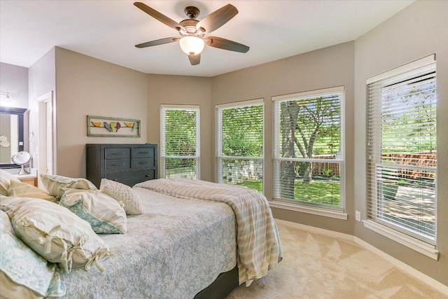 12505 Stapp Ct, Austin, TX 78732 - carpeted bedroom with multiple windows, baseboards, and ceiling fan