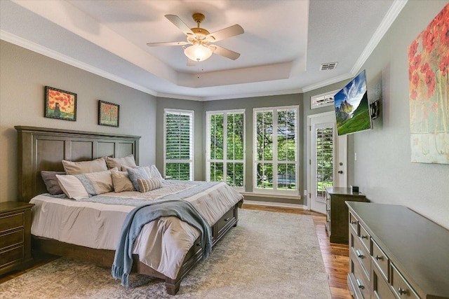 12505 Stapp Ct, Austin, TX 78732 - bedroom with a raised ceiling, wood finished floors, access to exterior, ornamental molding, and ceiling fan