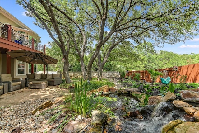 12505 Stapp Ct, Austin, TX 78732 - fenced backyard with outdoor lounge area, a balcony, a patio, and a small pond