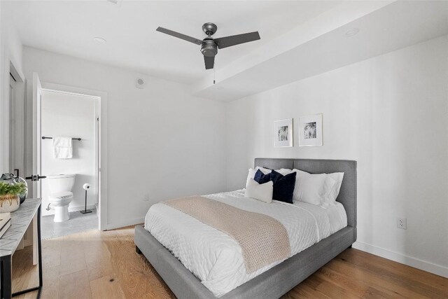 1800 E 4th St Unit 396, Austin, TX 78702 - bedroom with light wood finished floors, baseboards, ensuite bathroom, and ceiling fan