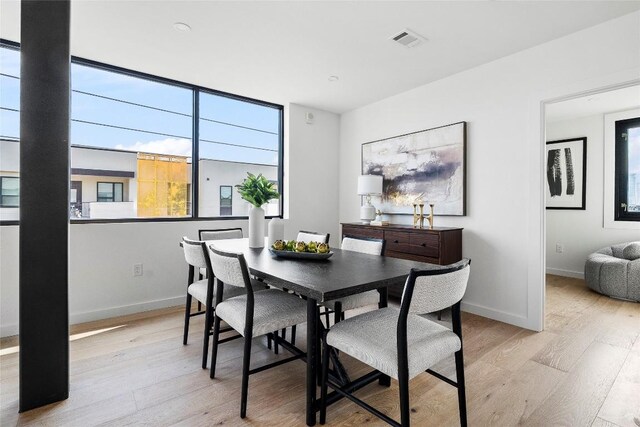 1800 E 4th St Unit 396, Austin, TX 78702 - dining room with light wood-style flooring and baseboards