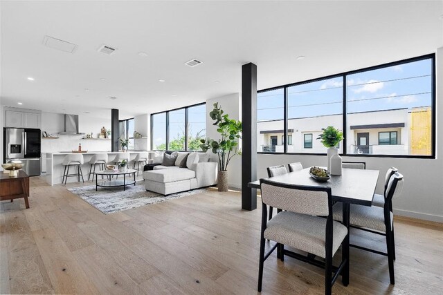 1800 E 4th St Unit 396, Austin, TX 78702 - dining space with light wood-style floors, recessed lighting, and baseboards