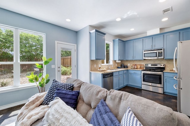 3407 Banton Rd Unit A, Austin, TX 78722 - kitchen featuring appliances with stainless steel finishes, open floor plan, plenty of natural light, tasteful backsplash, and recessed lighting