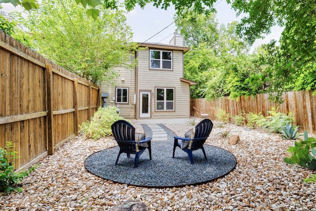 3407 Banton Rd Unit A, Austin, TX 78722 - back of property featuring a chimney and a fenced backyard