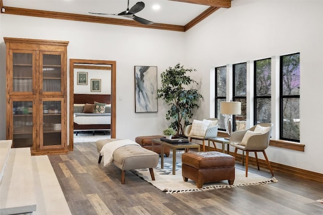 119 Vicinity Trl, Spicewood, TX 78669 - sitting room with a ceiling fan, wood finished floors, ornamental molding, beamed ceiling, and a high ceiling