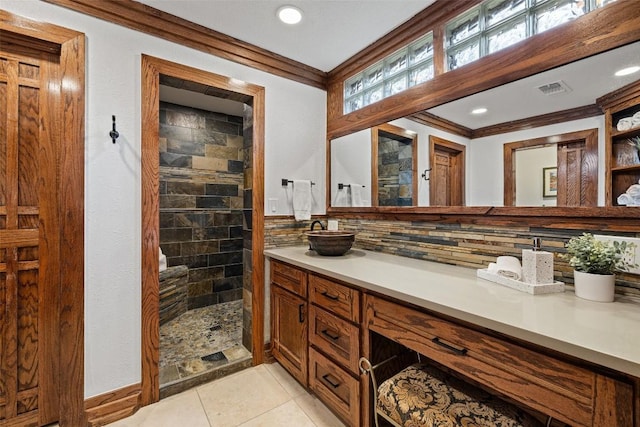 119 Vicinity Trl, Spicewood, TX 78669 - bathroom with crown molding, vanity, walk in shower, decorative backsplash, and tile patterned floors