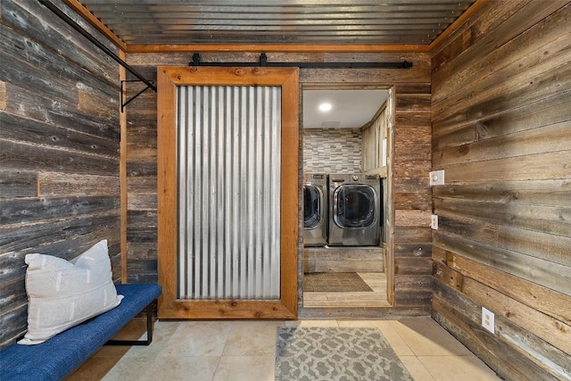 119 Vicinity Trl, Spicewood, TX 78669 - washroom with washer and dryer, wood walls, and tile patterned flooring