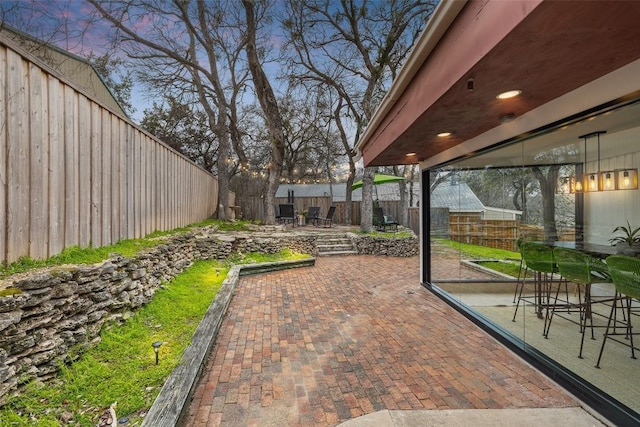 119 Vicinity Trl, Spicewood, TX 78669 - fenced backyard with a patio area and outdoor dining space