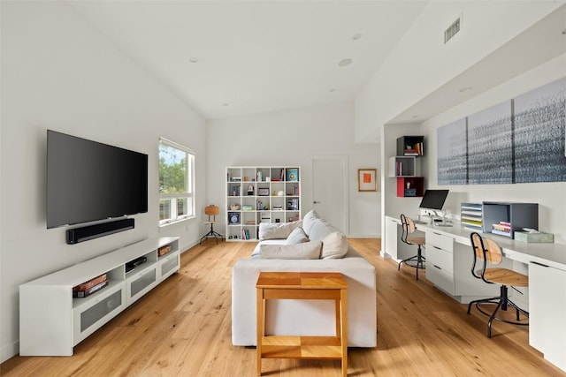 4005 Knollwood Dr, Austin, TX 78731 - living room with light wood finished floors, a desk, and high vaulted ceiling