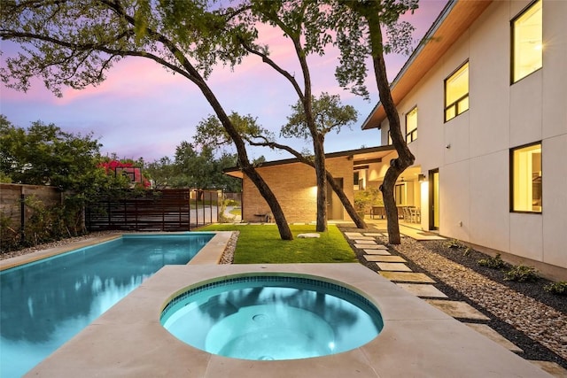 4005 Knollwood Dr, Austin, TX 78731 - pool at dusk with an in-ground hot tub