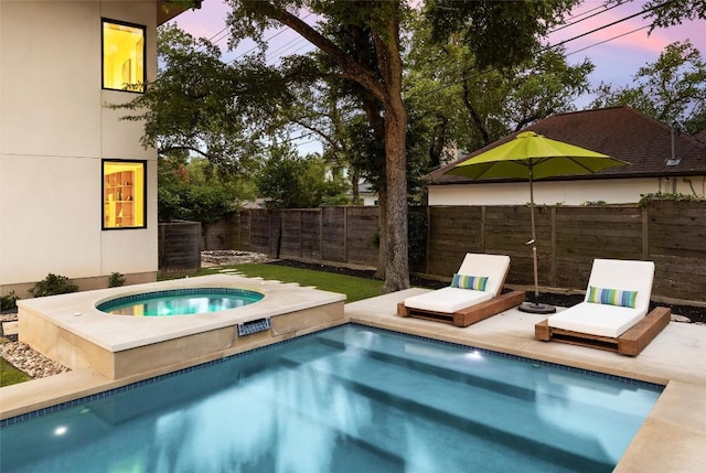 4005 Knollwood Dr, Austin, TX 78731 - pool at dusk with an in-ground hot tub and a fenced backyard