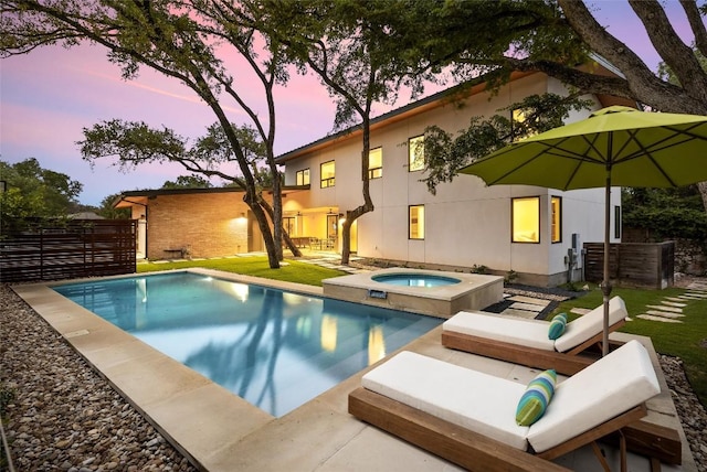 4005 Knollwood Dr, Austin, TX 78731 - pool at dusk featuring an in-ground hot tub, an outdoor pool, and a patio