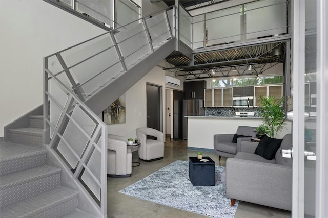 4801 S Congress Ave Unit A1, Austin, TX 78745 - living room with concrete flooring, stairway, and an AC wall unit