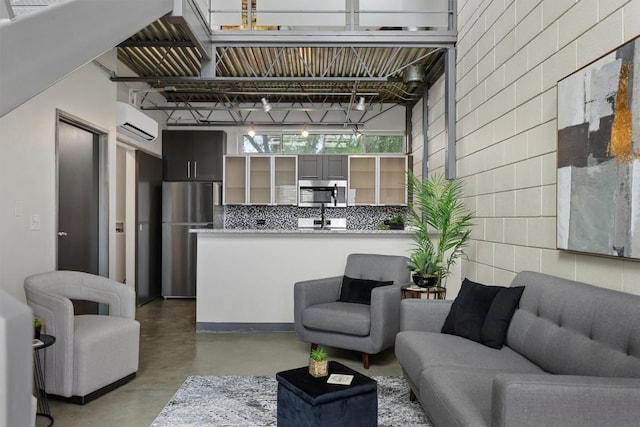 4801 S Congress Ave Unit A1, Austin, TX 78745 - living room with concrete flooring and a wall mounted AC