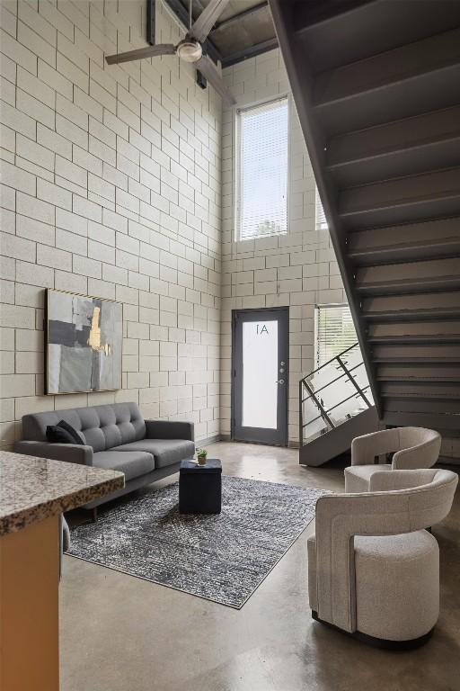 4801 S Congress Ave Unit A1, Austin, TX 78745 - living area featuring concrete floors and a towering ceiling
