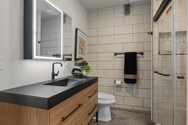 4801 S Congress Ave Unit A1, Austin, TX 78745 - bathroom with vanity, a stall shower, concrete flooring, and tile walls