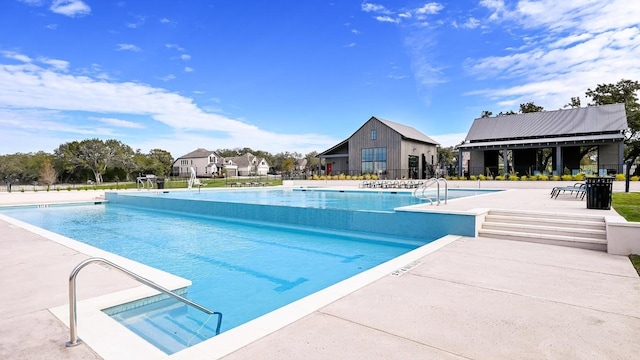 164 Coyote Creek Pass, Kyle, TX 78640 - community pool with a patio