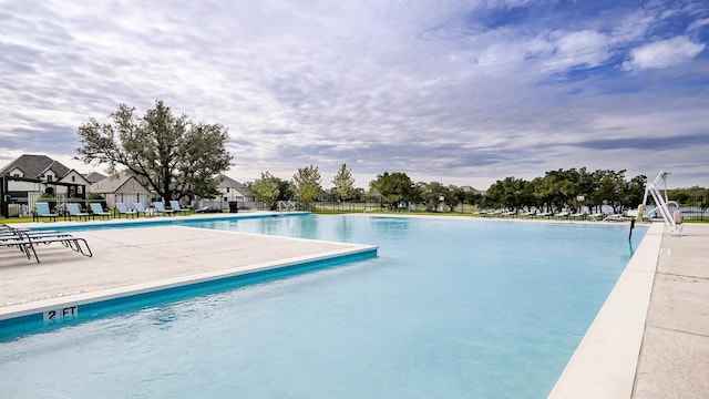 164 Coyote Creek Pass, Kyle, TX 78640 - community pool featuring a patio area