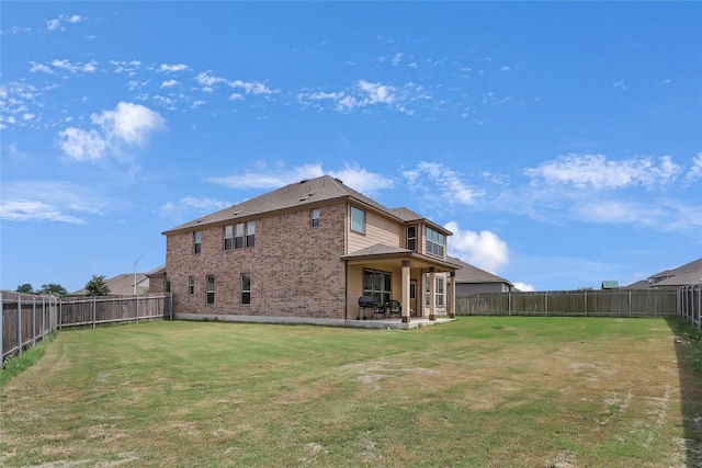 351 Jarbridge Dr, Kyle, TX 78640 - back of property featuring a fenced backyard, a patio, and brick siding