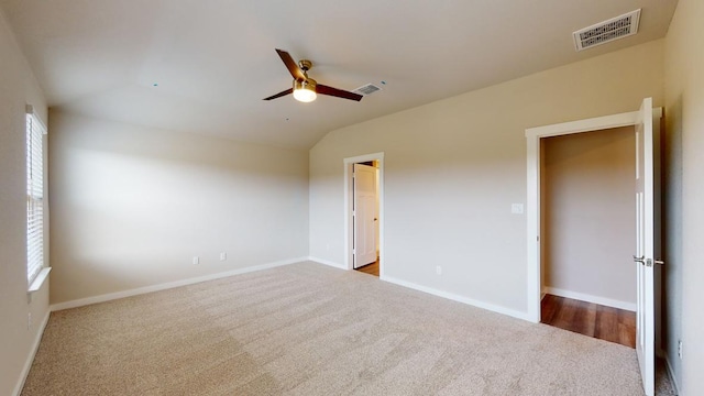 4019 Illian Cv, Killeen, TX 76542 - empty room with dark colored carpet, ceiling fan, vaulted ceiling, and baseboards