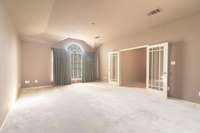 8006 Monona Ave, Austin, TX 78717 - unfurnished room featuring french doors, lofted ceiling, light colored carpet, and baseboards