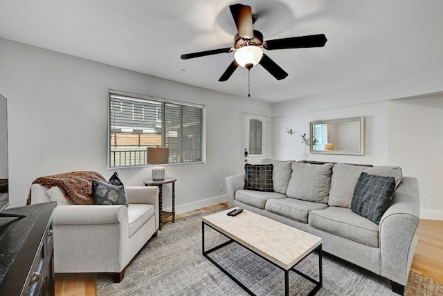 1307 Norwalk Ln Unit 104, Austin, TX 78703 - living area with light wood finished floors, ceiling fan, and baseboards