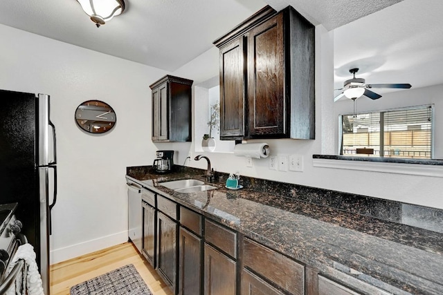 1307 Norwalk Ln Unit 104, Austin, TX 78703 - kitchen featuring a sink, dark brown cabinetry, stainless steel appliances, a ceiling fan, and light wood-style flooring