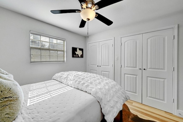 1307 Norwalk Ln Unit 104, Austin, TX 78703 - bedroom with multiple closets, wood finished floors, and ceiling fan