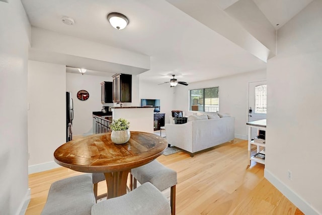 1307 Norwalk Ln Unit 104, Austin, TX 78703 - dining space with light wood-style floors, a ceiling fan, and baseboards