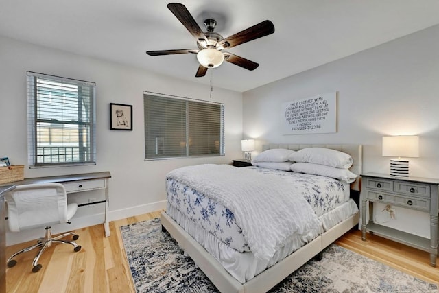 1307 Norwalk Ln Unit 104, Austin, TX 78703 - bedroom with light wood finished floors, baseboards, a ceiling fan, and a desk