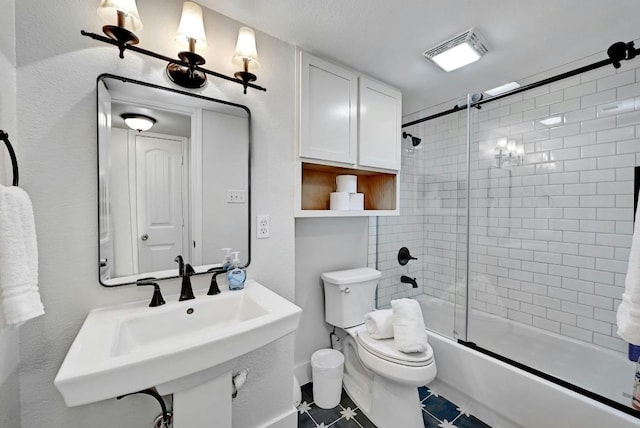 1307 Norwalk Ln Unit 104, Austin, TX 78703 - full bath featuring toilet, combined bath / shower with glass door, baseboards, tile patterned flooring, and a sink