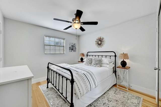 1307 Norwalk Ln Unit 104, Austin, TX 78703 - bedroom with light wood-style flooring, baseboards, and ceiling fan