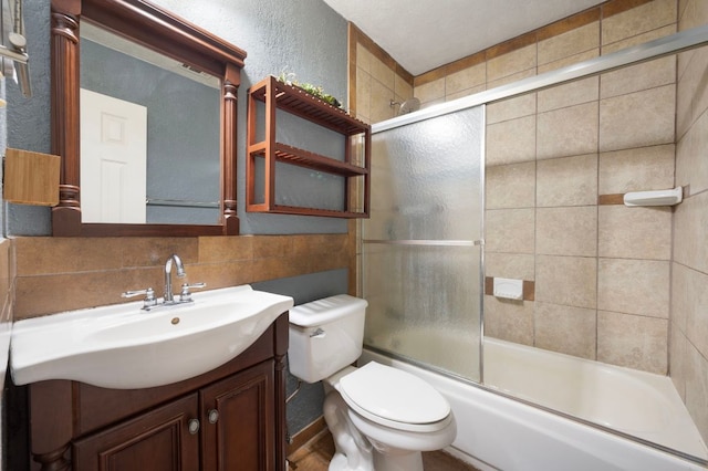 113 Arikara St, Buda, TX 78610 - full bath with toilet, vanity, combined bath / shower with glass door, and a textured wall