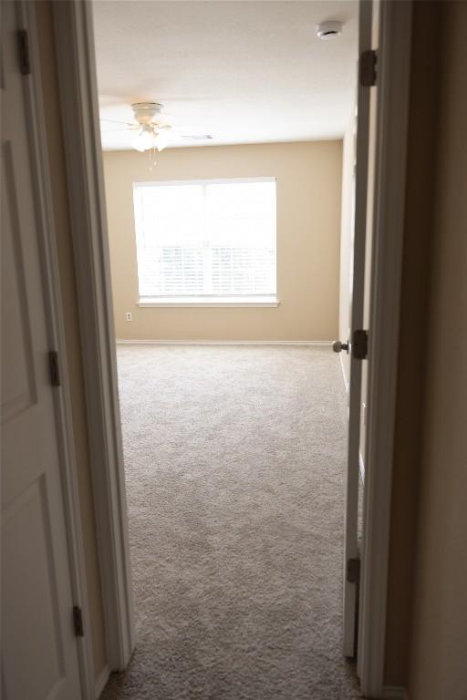 12 Verde Ranch Loop, Leander, TX 78641 - hallway with carpet flooring and baseboards