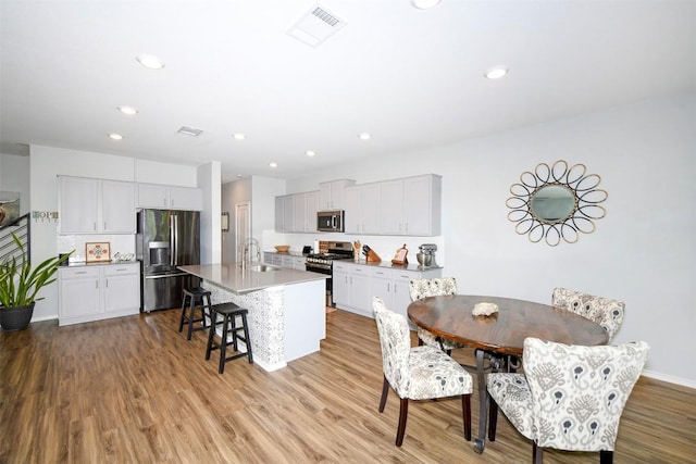 10401 Bramble Berry Dr, Austin, TX 78748 - dining room with light wood-style flooring and recessed lighting