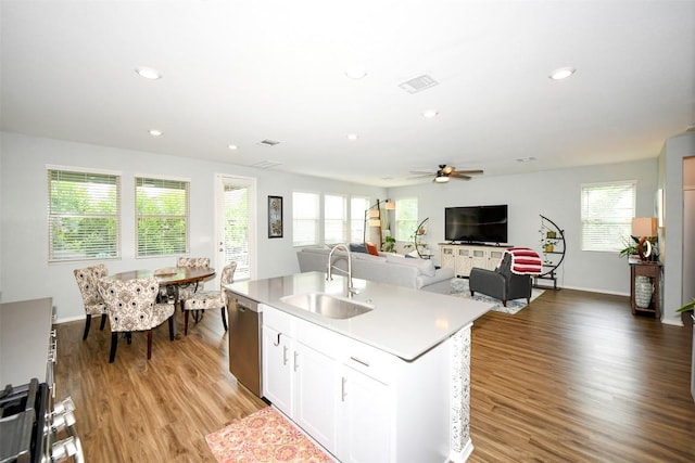 10401 Bramble Berry Dr, Austin, TX 78748 - kitchen featuring dishwasher, ceiling fan, light wood-type flooring, recessed lighting, and a center island with sink