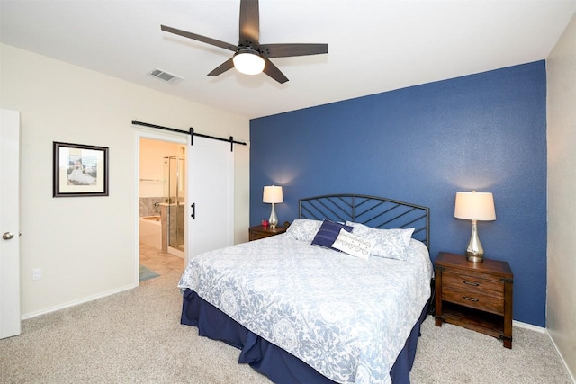 10401 Bramble Berry Dr, Austin, TX 78748 - carpeted bedroom featuring a barn door, a ceiling fan, and connected bathroom