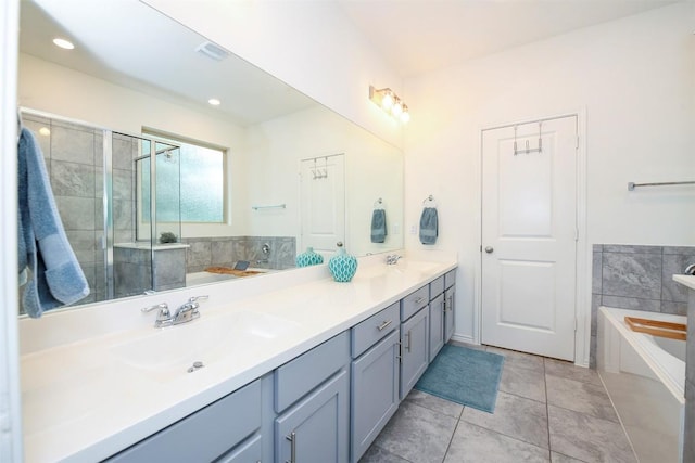 10401 Bramble Berry Dr, Austin, TX 78748 - bathroom with a garden tub, double vanity, tile patterned floors, tiled shower, and recessed lighting