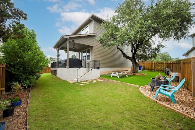 10401 Bramble Berry Dr, Austin, TX 78748 - back of house with an outdoor fire pit, a fenced backyard, a ceiling fan, and stairs