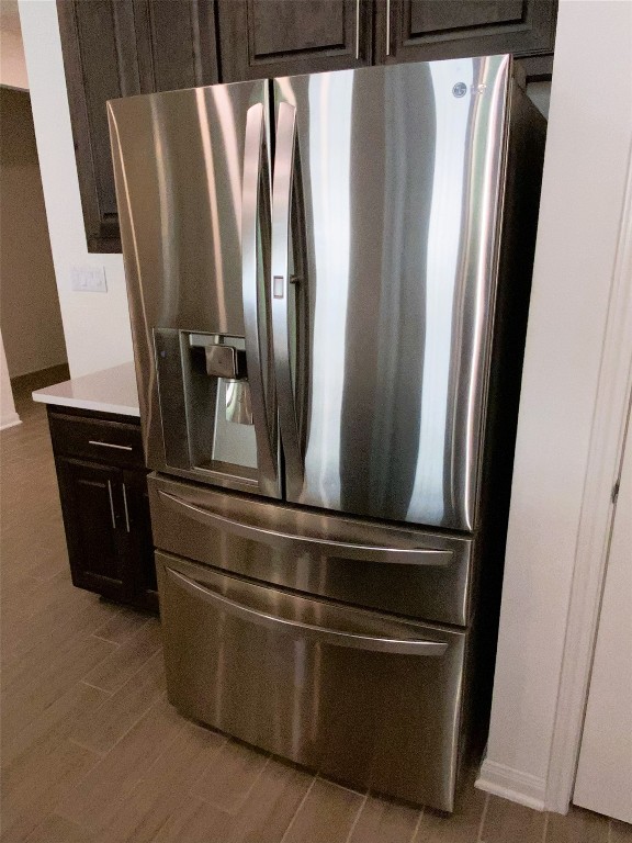 19024 Fernando Trl, Austin, TX 78738 - kitchen view of stainless steel fridge with ice dispenser, dark brown cabinetry, and light countertops