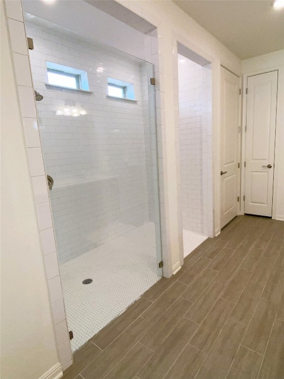 19024 Fernando Trl, Austin, TX 78738 - bathroom featuring wood finished floors and tiled shower