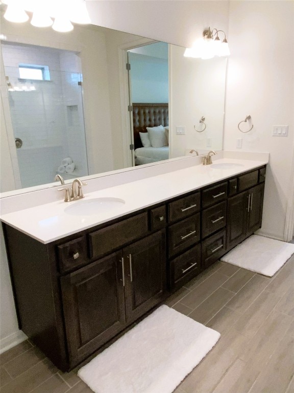 19024 Fernando Trl, Austin, TX 78738 - full bathroom featuring double vanity and wood finished floors