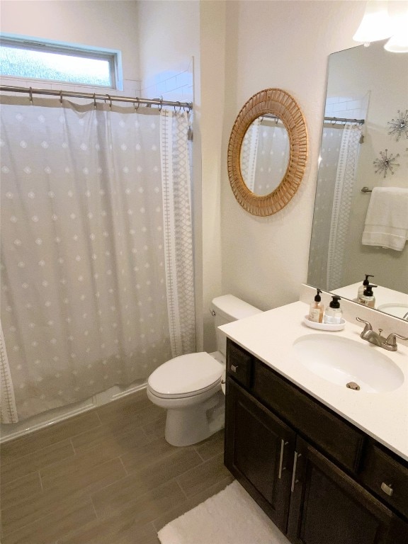 19024 Fernando Trl, Austin, TX 78738 - bathroom with toilet, vanity, a shower with curtain, and wood finished floors