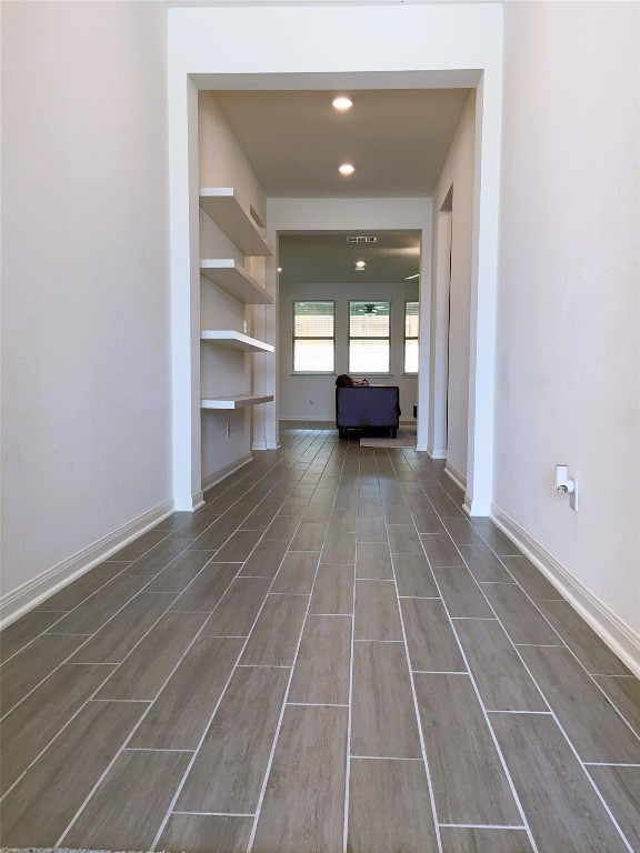 19024 Fernando Trl, Austin, TX 78738 - unfurnished living room featuring wood finished floors, baseboards, and recessed lighting