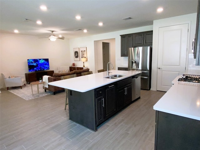 19024 Fernando Trl, Austin, TX 78738 - kitchen featuring appliances with stainless steel finishes, a sink, light countertops, a kitchen island with sink, and recessed lighting