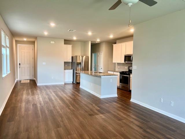 232 Serpens St, Georgetown, TX 78628 - kitchen featuring stainless steel appliances, dark wood finished floors, recessed lighting, a ceiling fan, and an island with sink