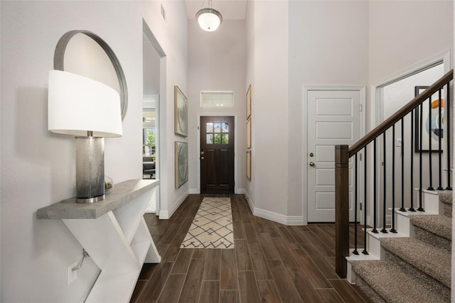 620 Saturnia Dr, Georgetown, TX 78628 - entryway featuring a towering ceiling, stairs, and dark wood-style floors