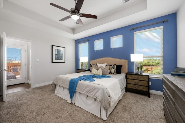 620 Saturnia Dr, Georgetown, TX 78628 - bedroom with a tray ceiling, light carpet, and ceiling fan