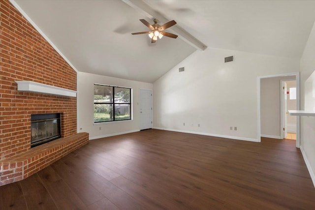 910 Garwood St, Smithville, TX 78957 - unfurnished living room with dark wood-style flooring, ceiling fan, beamed ceiling, a fireplace, and high vaulted ceiling